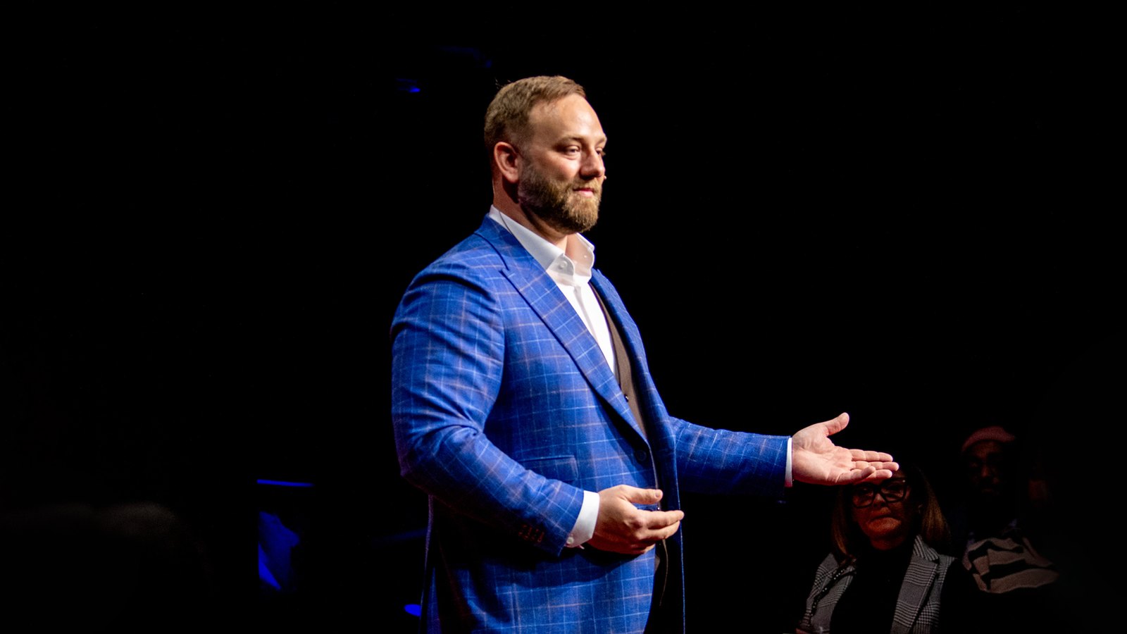 Phil Neil speaking on stage